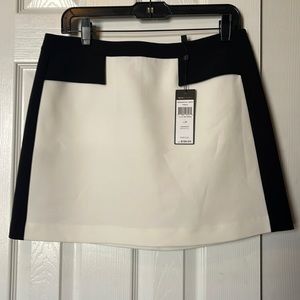 Structured black and white skirt with faux pockets